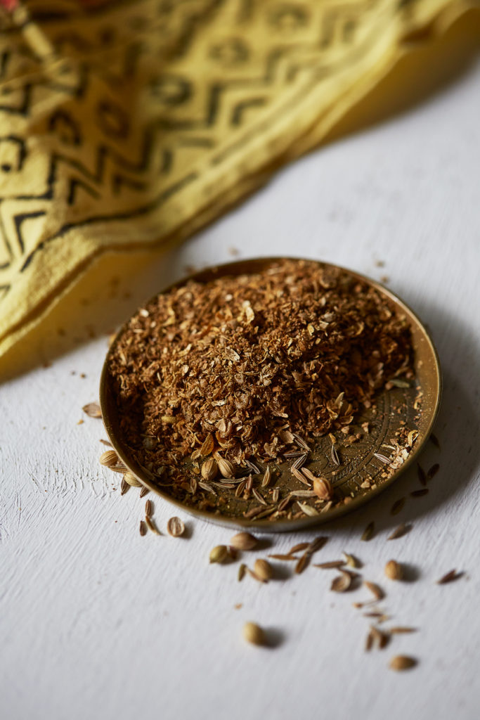 Dry roasted and ground cumin and coriander seeds in a small brass dish