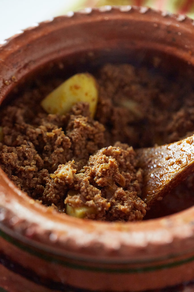 Close-up shot of Keema Aloo Curry in a traditional clayware pot or handi.