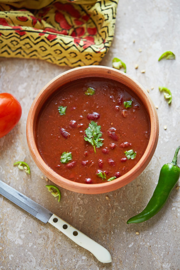 Rajma Masala or Lal Lobia (Red Kidney Bean Curry) in a clay bowl, garnished with coriander, shot overhead.