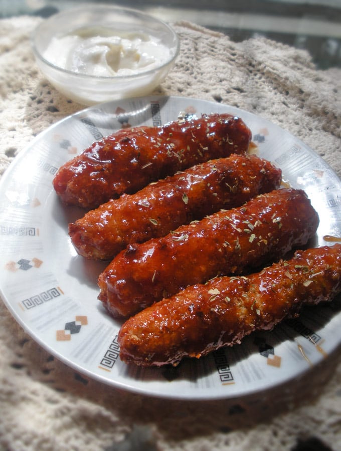  Sweet and Spicy Chicken Sticky Fingers served with a garlic mayo dip.